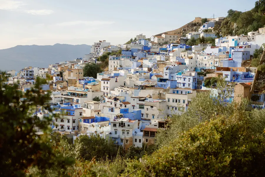 Blue-washed buildings of Chefchaouen medina nestled on the mountain slope