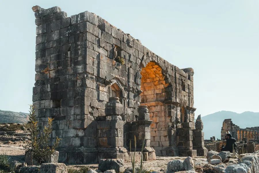 Arch of Caracalla and stone basilica columns at the Roman site of Volubilis