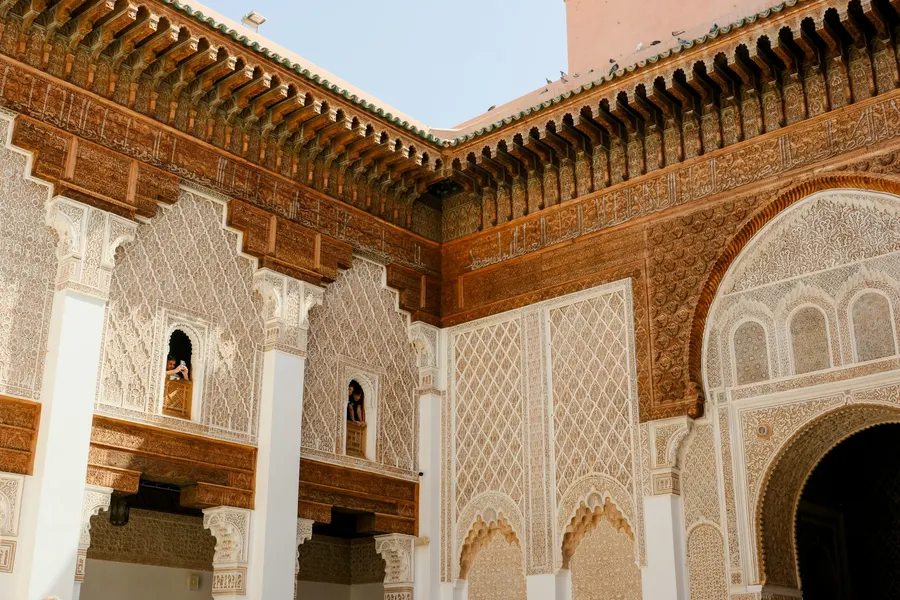 Ornate carved cedar and plasterwork courtyard of Ben Youssef Madrasa