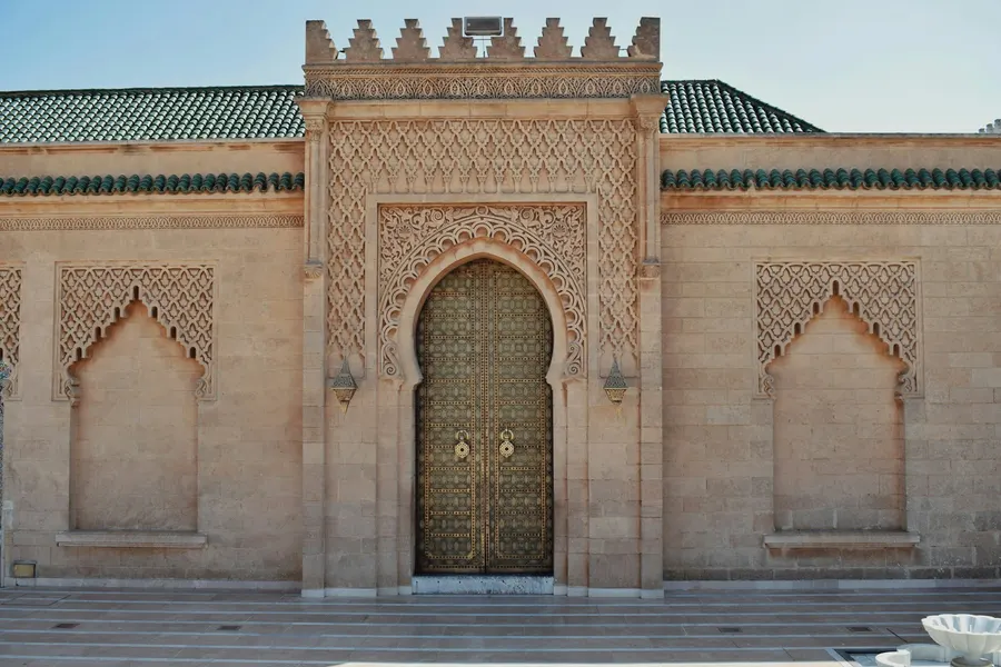 Carved stone arch and bronze doors of the Mausoleum of Mohammed V in Rabat