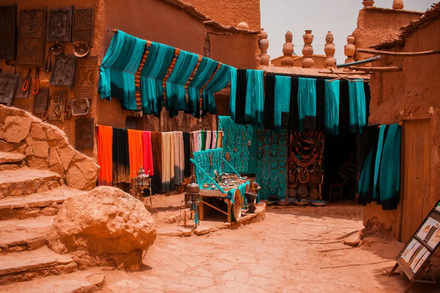 Bright blue scarves and Berber crafts displayed in Ait Ben Haddou