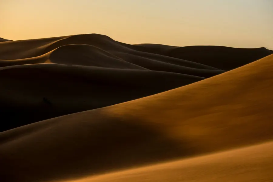 Shadows and golden sunlight contouring the dunes of Erg Chebbi