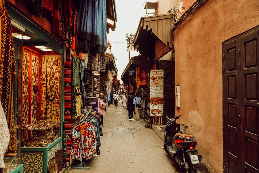 Narrow artisan souk alley in Fes old medina with jewelry shops