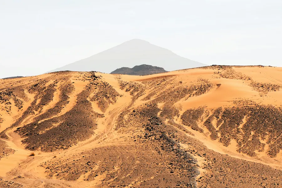 Rocky volcanic hills and desert mountain peak near Merzouga