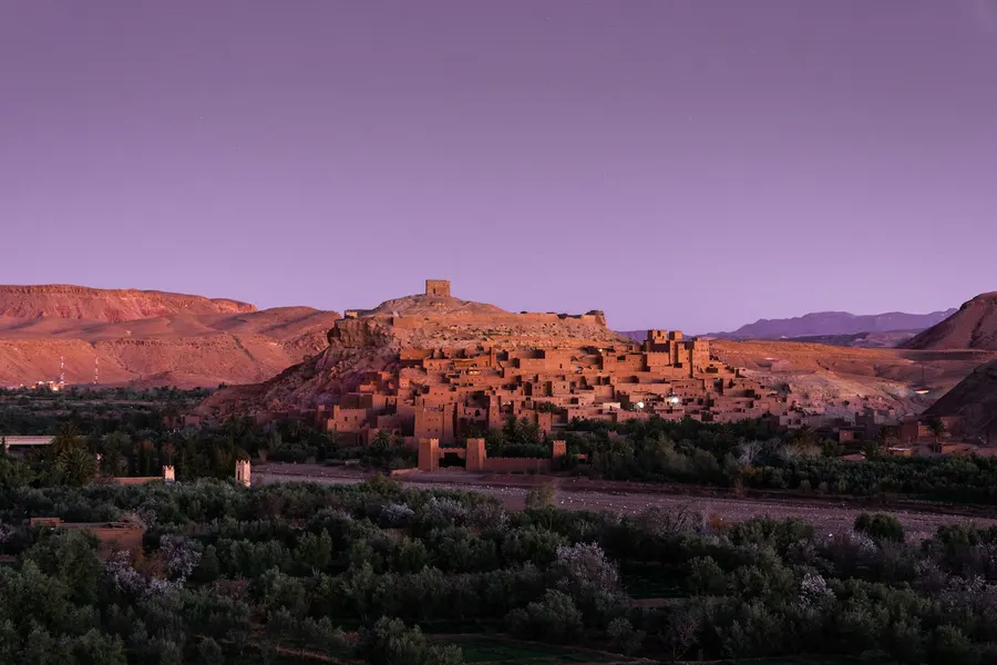 Twilight purple sky over the illuminated clay village of Ait Ben Haddou