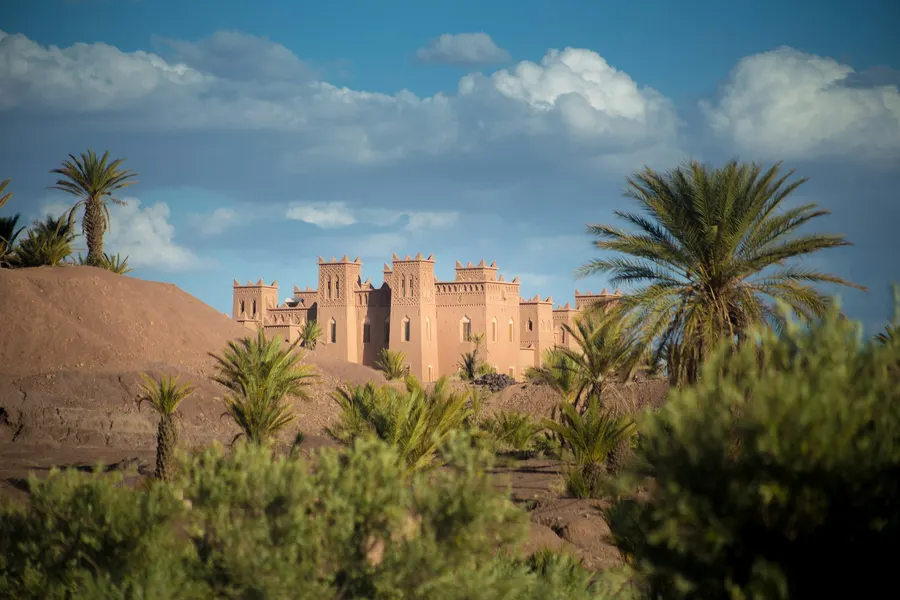 Fortified earthen kasbah rising amidst palm trees in Skoura oasis