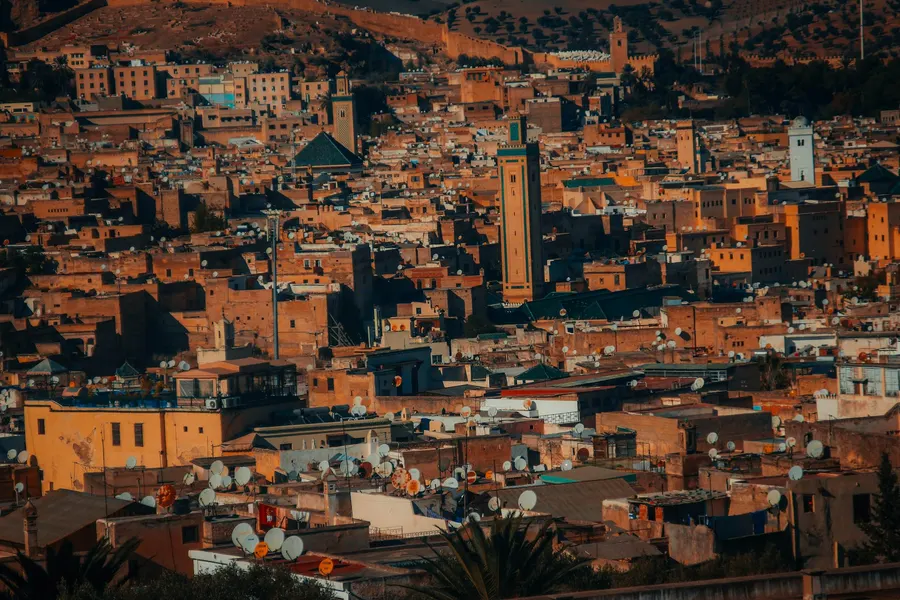 Historic earthen kasbah standing beside date palms in Dades Valley