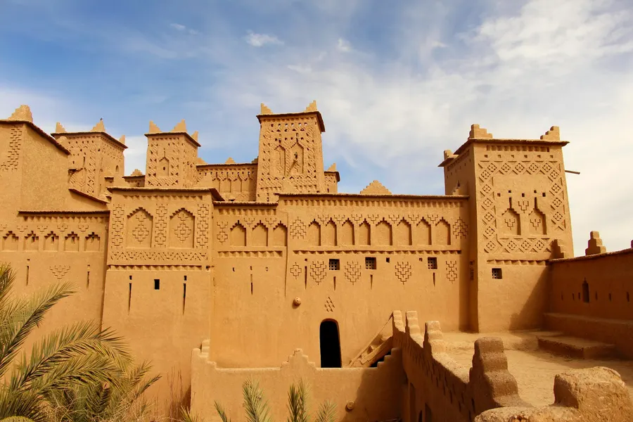Historic Al Attarine Madrasa courtyard with intricate arabesques in Fes