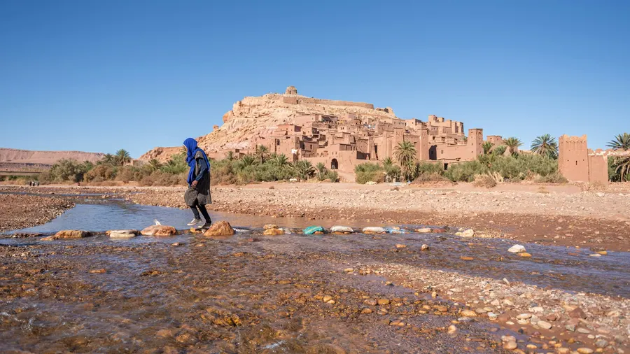 Red clay kasbahs and terraced gardens along the Dades River valley
