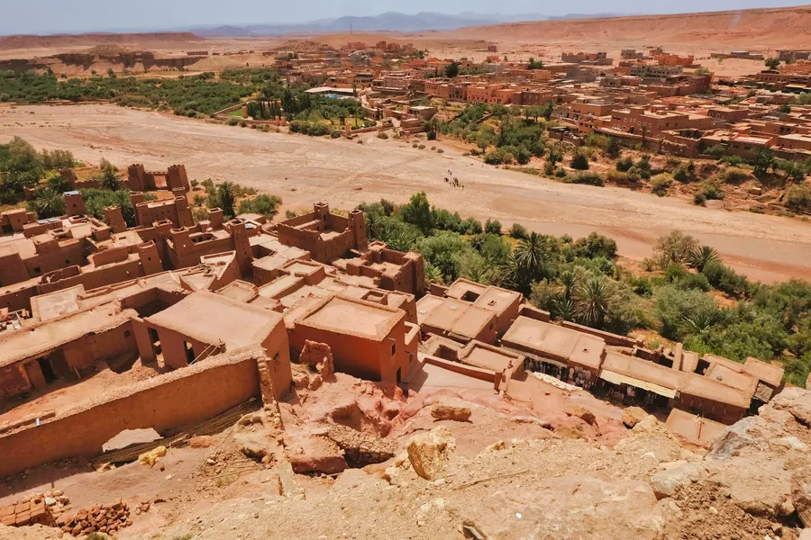 Fortified earthen walls of Taourirt Kasbah under blue sky in Ouarzazate