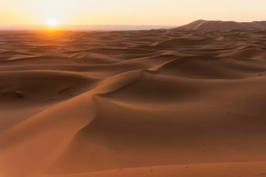 Desert glamping camp with luxury tents surrounded by Merzouga sand dunes